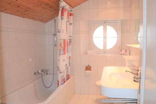 a bathroom with a tub and a sink and a shower at Bisang R in Arosa