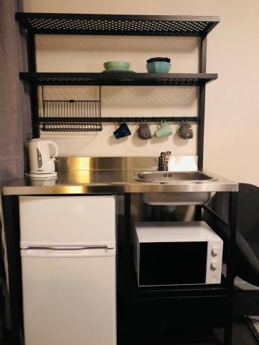 a kitchen with a sink and a microwave at Best Western Hotel Solna in Solna
