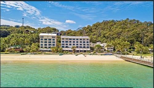 a large building with a pool of water in front of it at Moreton Island Villas and Apartments in Tangalooma