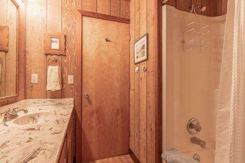 a bathroom with a sink and a shower and a mirror at Amazing Place MCA 1295 - Meredith Lodging in Manzanita
