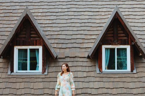a woman standing in front of a house at Suan Sai Yok Resort in Sai Yok