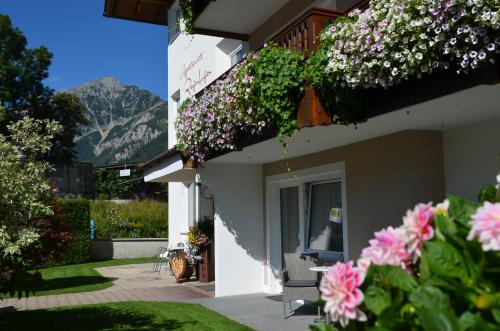 a house with flowers on the side of it at Haus Regenbogen in Pertisau