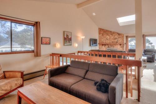 a living room with a couch and a table at Captain Johns in Lincoln City