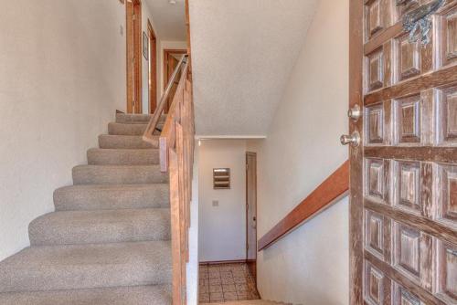 a staircase in a house with a wooden door at Captain Johns in Lincoln City