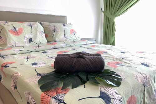 a bed with a comforter with a pillow on it at ZY Studio @ EVO SOHO Bangi [ASTRO WiFi NETFLIX] in Bangi
