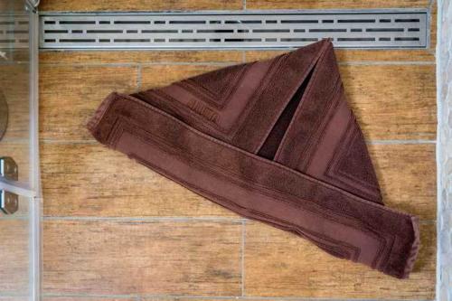 a brown towel sitting on top of a wooden floor at Ferienhaus Boje 9 in Neuharlingersiel