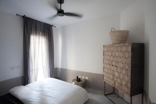 a bedroom with a white bed and a window at Etis garden seafront in Haifa
