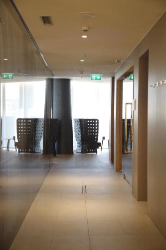 a hallway of an office with chairs and glass doors at Maritim Hotel Plaza Tirana in Tirana