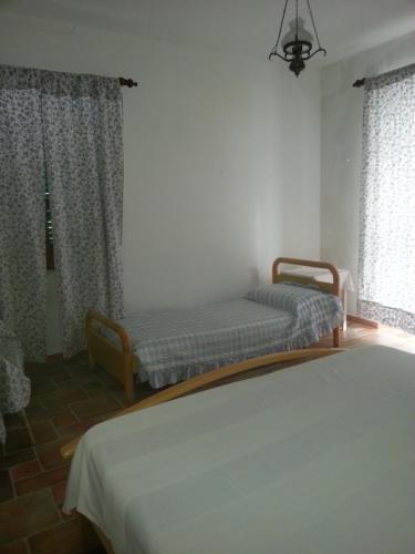 a bedroom with two beds and a window at Villetta Frasena in Santa Maria