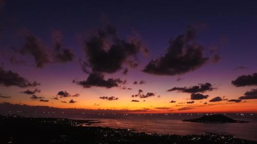 a sunset over the ocean with clouds in the sky at Hi Jeju Hotel in Jeju