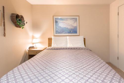 a bedroom with a bed and a picture on the wall at Dock of the Bay 305 in Lincoln City