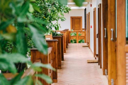 an aisle in a church with potted plants at Huen Him Kong Hotel Phrae in Phrae