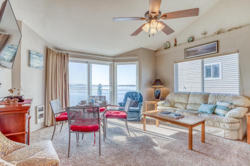 a living room with a couch and a table and chairs at Dock of the Bay 308 in Lincoln City