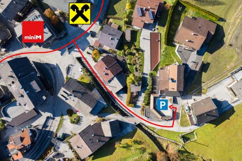 an overhead view of a street with houses and a road at Alpenapart Hochzeiger in Jerzens