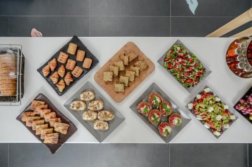a table with different types of food on it at Lianos Village in Agios Prokopios