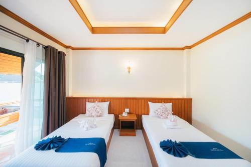 Krevet ili kreveti u jedinici u okviru objekta Huen Him Kong Hotel Phrae