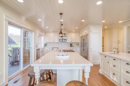 a kitchen with a large white island with two sinks at Netarts Coastal Retreat - Meredith Lodging in Tillamook