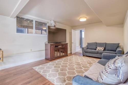 a living room with a couch and a flat screen tv at Netarts Coastal Retreat - Meredith Lodging in Tillamook