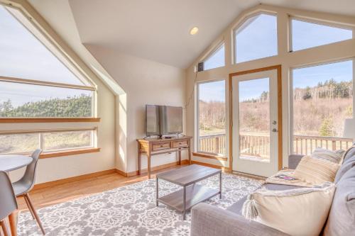 a living room with a couch and a tv at Netarts Coastal Retreat - Meredith Lodging in Tillamook