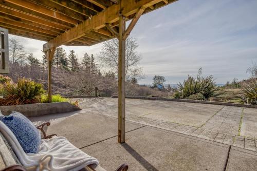 a patio with a rocking chair on a porch at Netarts Coastal Retreat - Meredith Lodging in Tillamook