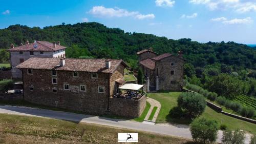 an aerial view of a large stone building on a hill at Agriturismo Ronchi Di Sant'Egidio in Manzano