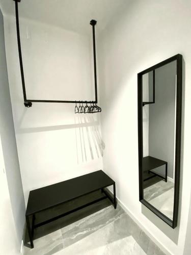 a mirror and a bench next to a mirror at IL RICCIO Rooms in Milan