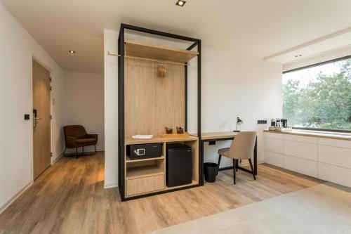 a kitchen with a counter and a table and chairs at Hotel de Rousch - 4 sterren Superieur in Heerlen