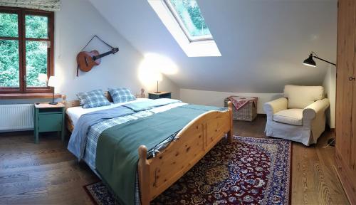 a bedroom with a bed and a chair at Apartament Międzygórze in Miedzygorze