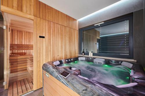 a jacuzzi tub in a room with a window at Villa Ansi by Villas Holiday in Višnjan