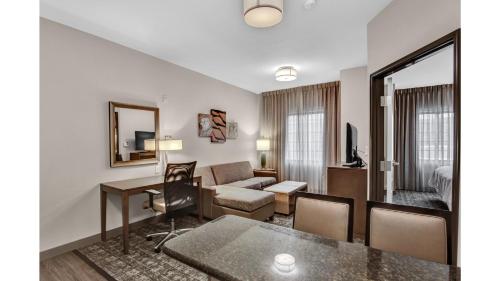 a living room with a couch and a table at Staybridge Suites Salt Lake-West Valley City by IHG in West Valley City
