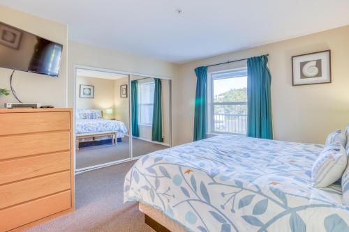 a bedroom with a bed and a dresser and a mirror at Birds Nest Suite in Lincoln City