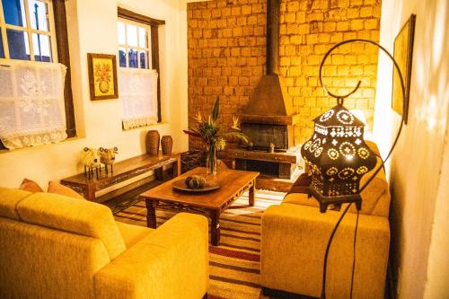 a living room with two couches and a fireplace at Pouso do Bichinho 1 in Bichinho