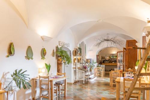 a restaurant with tables and chairs in a room at Son Borguny in Banyalbufar