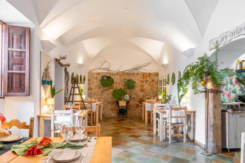 a restaurant with tables and chairs and a brick wall at Son Borguny in Banyalbufar