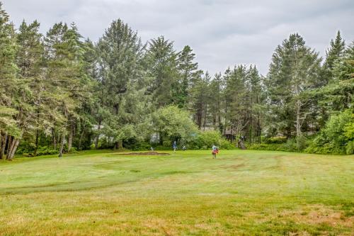 a golfer is standing on a lush green field at Cabin on the Coast MCA 621 - Meredith Lodging in Manzanita