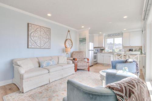 a living room with a couch and chairs and a kitchen at Ohana Shores in Lincoln City