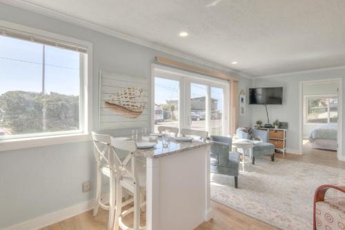 a kitchen and living room with a large window at Ohana Shores in Lincoln City