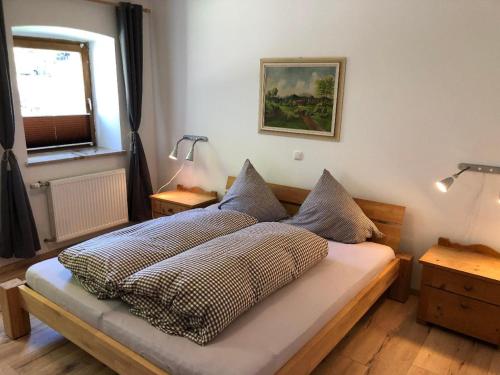 a bedroom with a bed with two pillows on it at Urlaub auf dem Weberhof in Waldkirchen