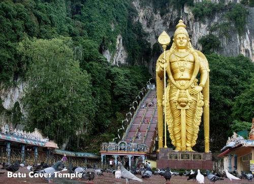 a large gold statue in front of a mountain at The Lake-ville KL Jalan Kuching by M Platinum in Kuala Lumpur