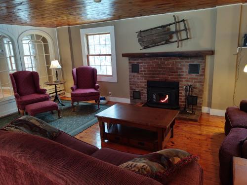 a living room with a couch and a fireplace at Doveberry Inn in West Dover