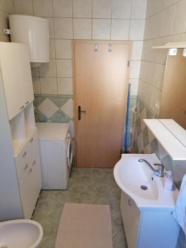 a small bathroom with a sink and a toilet at Apartment Kika *** in Pučišća