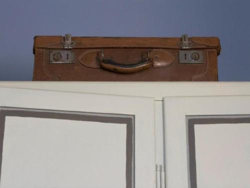 a suitcase is sitting on top of a door at Palazzo Romani Adami in Fermo