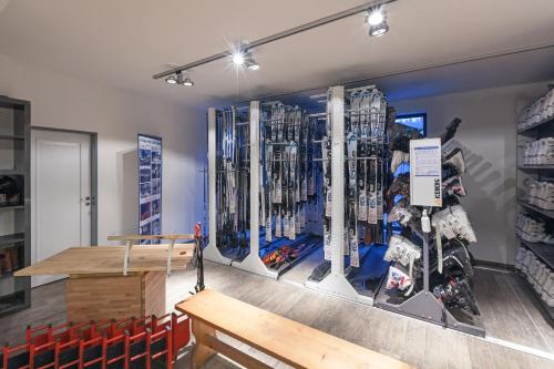 a room with a wall with a display of ski equipment at Hotel U Kabinky in Janske Lazne