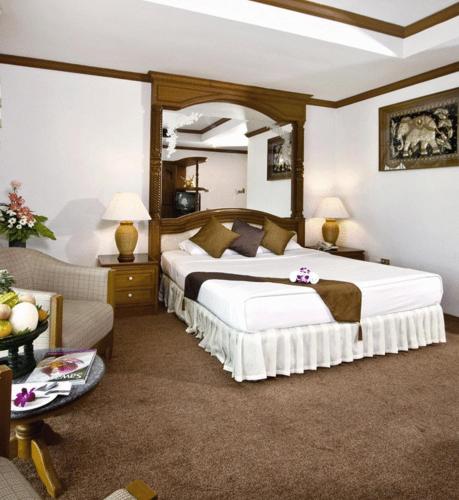 a bedroom with a large bed in a room at Chiangmai Ratanakosin Hotel in Chiang Mai