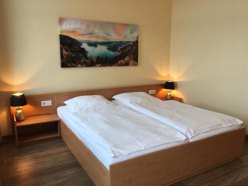 a bedroom with a bed and a painting on the wall at Hotel Kieler Förde in Kiel