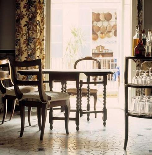 a dining room with a table and chairs at Palazzo Romani Adami in Fermo