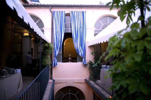 a building with blue curtains on the side of it at Palazzo Romani Adami in Fermo