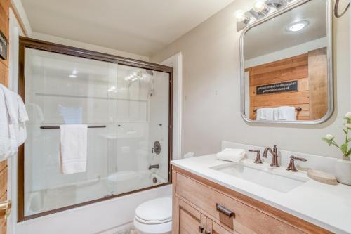 a bathroom with a shower and a sink and a toilet at Pole House 15 - Meredith Lodging in Sunriver