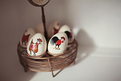 a basket full of eggs with chickens on them at Auberge Carpe Diem in Baie-Saint-Paul
