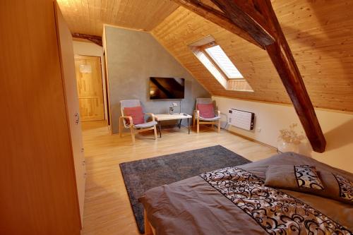 a bedroom with a bed and a table and chairs at Holiday Home Kvitek in Ctětín